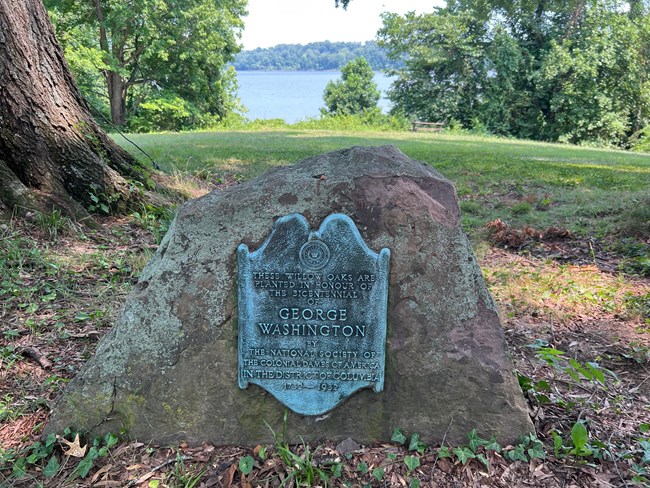 A plaque attached to a stone.