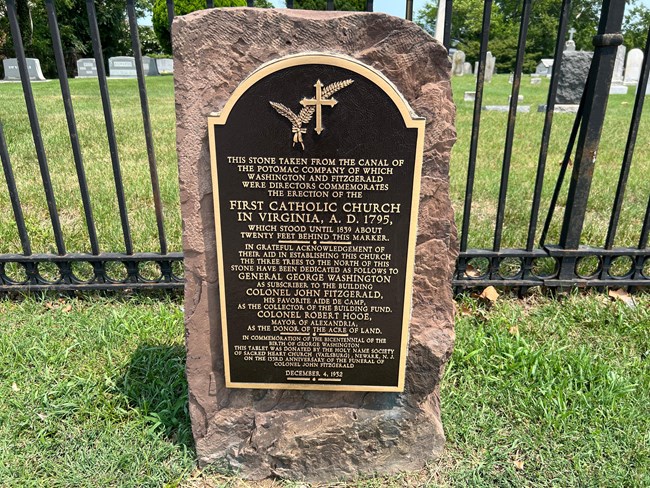 A plaque attached to a stone.