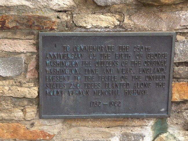 A plaque attached to a stone.