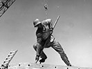 Part of the statue (Harlon Block) is lowered into place by a crane