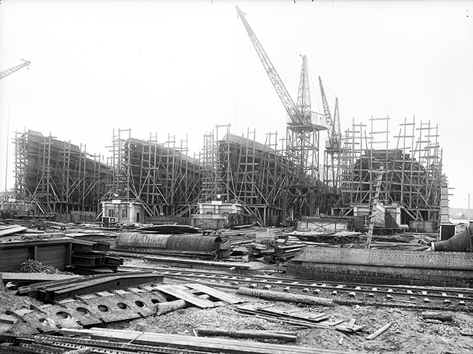 Four partly completed ships line the shore in Alexandria