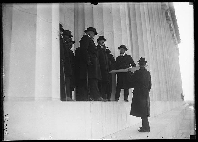 President Harding at Lincoln Memorial looking at Arlington Memorial Bridge site in 1922 or 1923.