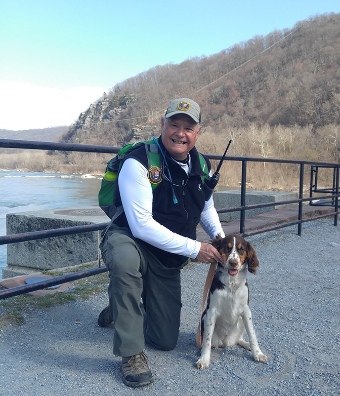 a volunteer poses with his dog