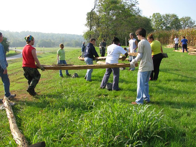 Students from Doane Academy building worm fencing. (NPS PHOTO) Students from Doane Academy building worm fencing. (NPS PHOTO)
