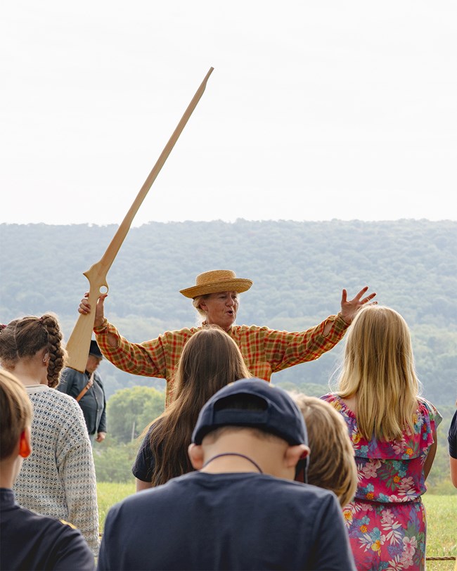Park Ranger in period clothing teaching students about the Civil War.