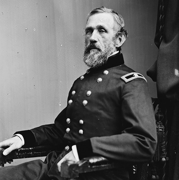 John G. Barnard seated, dressed in military uniform, posing in a photo studio