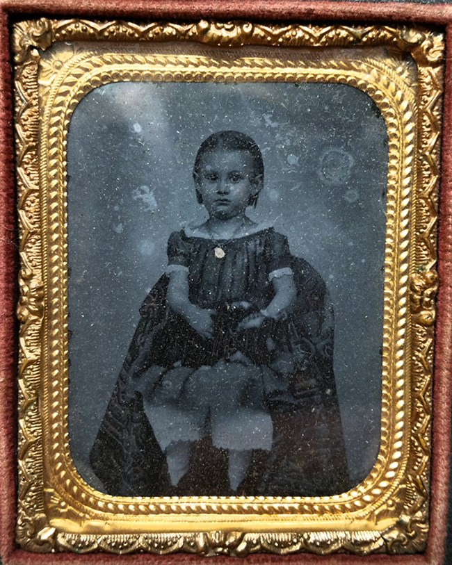 Daguerreotype image of young girl with doll