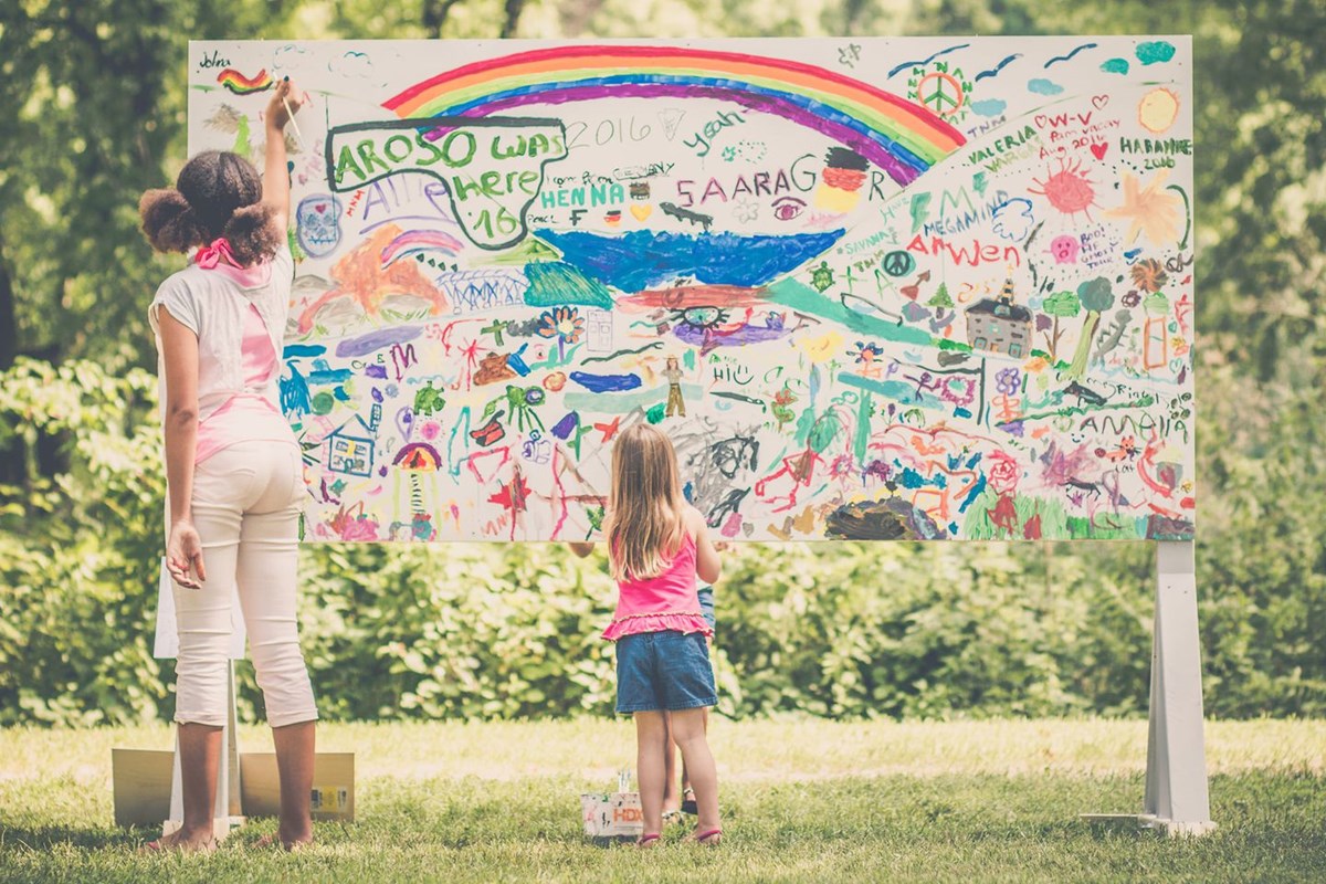 Two girls paint a mural
