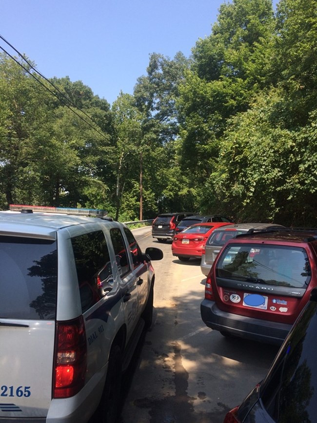 Cars parked on a narrow road