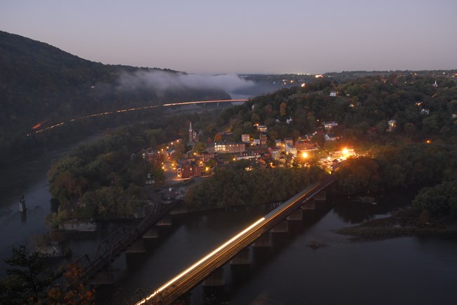 The view of Harpers Ferry lower town from above in Maryland Heights, taken at dusk.