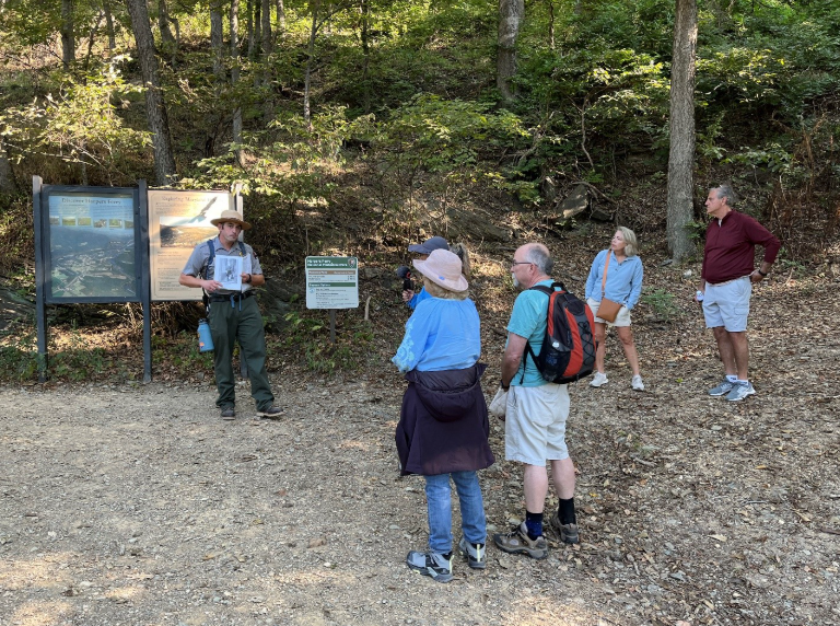 Park ranger speaks to a group of people at a trailhead at Harpers Ferry National Historical Park.