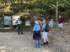 Park ranger speaks to a group of people at a trailhead at Harpers Ferry National Historical Park.
