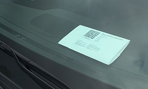 A park pass on a car dashboard.