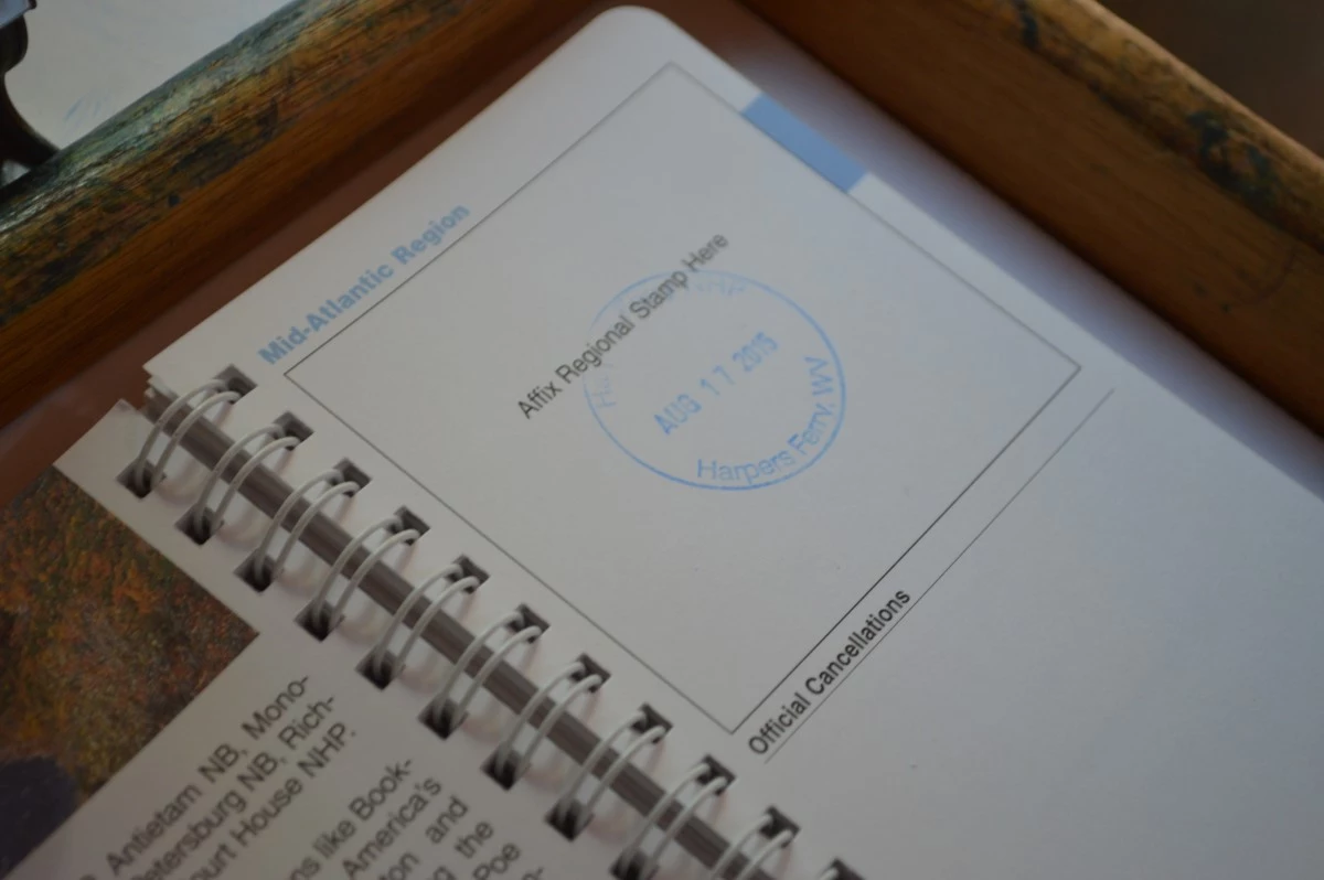 Harpers Ferry NHP Passport stamp Blue inked stamp on small book.