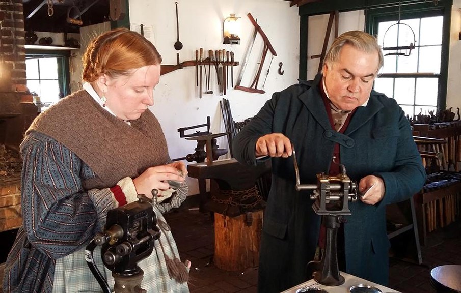 Volunteers practicing the art of tinsmithing Volunteers practicing the art of tinsmithing