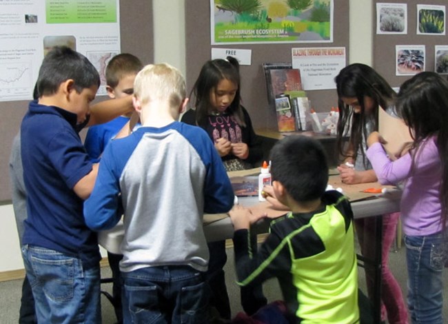 Students working on a project. Students working on a project.