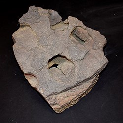 A slab of rock with a horse hoofprint impression