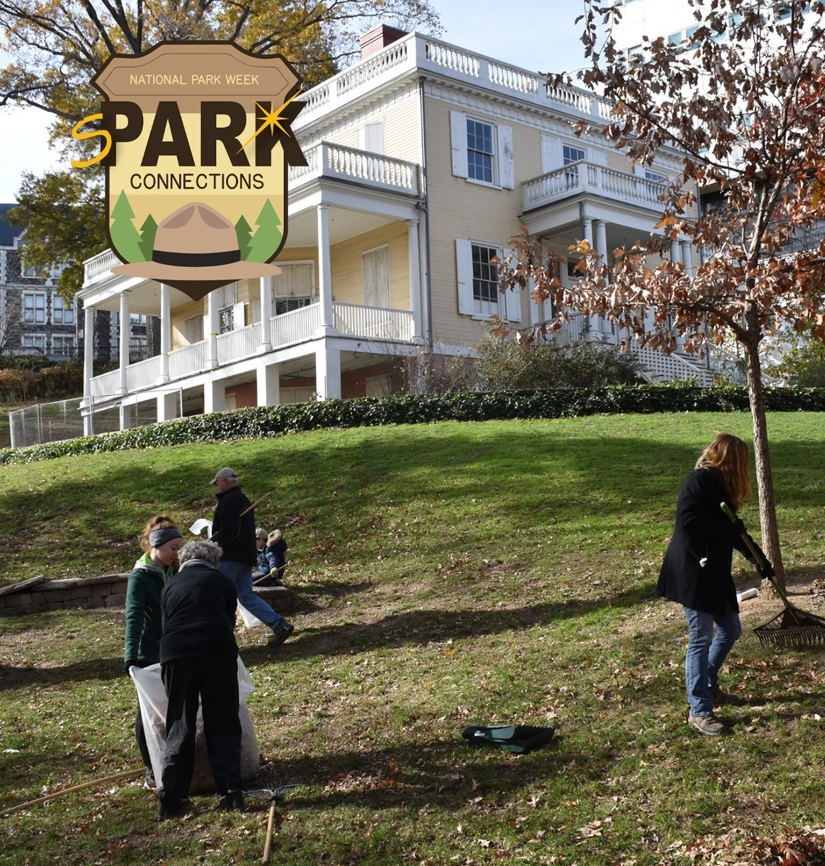 A group of people raking leaves in front of The Grange.