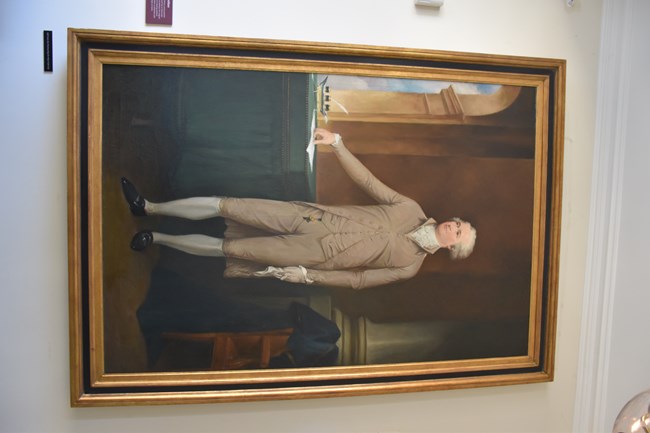 A painting of a man in a tan 18th century suit.