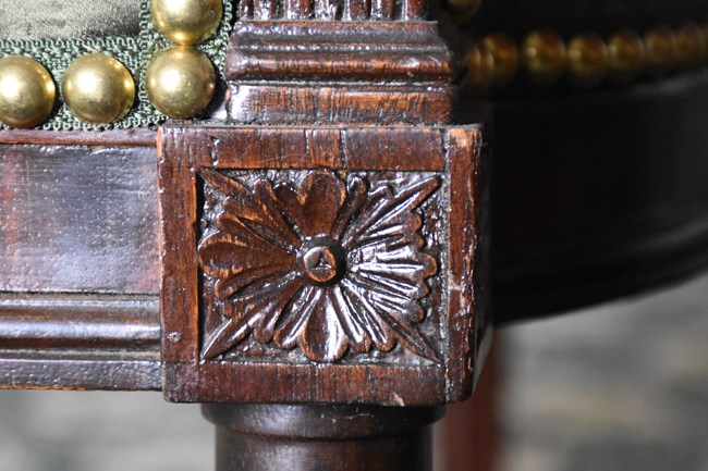 An engraving in wood of a flower.