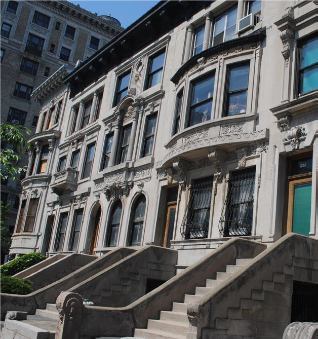 A row of brownstone apartments facing the street.