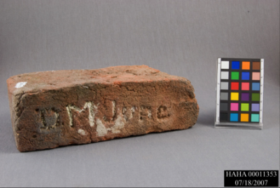 A brick engraved with 'D M June'