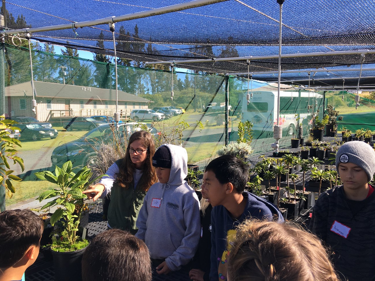 Students on a biodiversity field trip with park horticulturist learning about endangered species