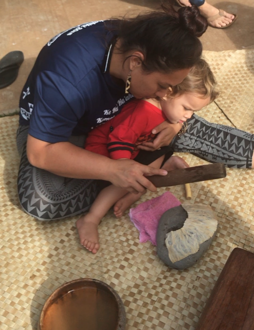 A teacher with a student on their lap