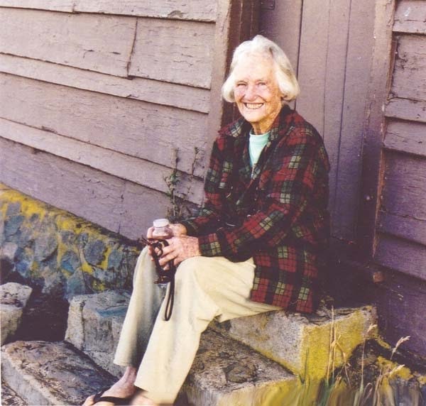 Mary sitting on steps of Kapalaoa Cabin
