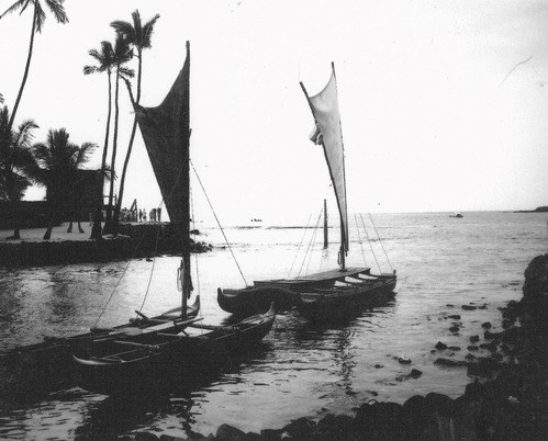 black and white photo of double hulled canoes in water