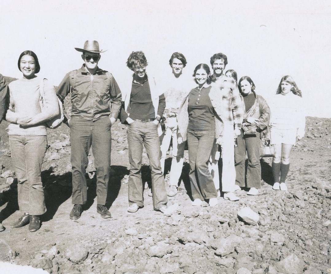 men and women hiking on rocky trail