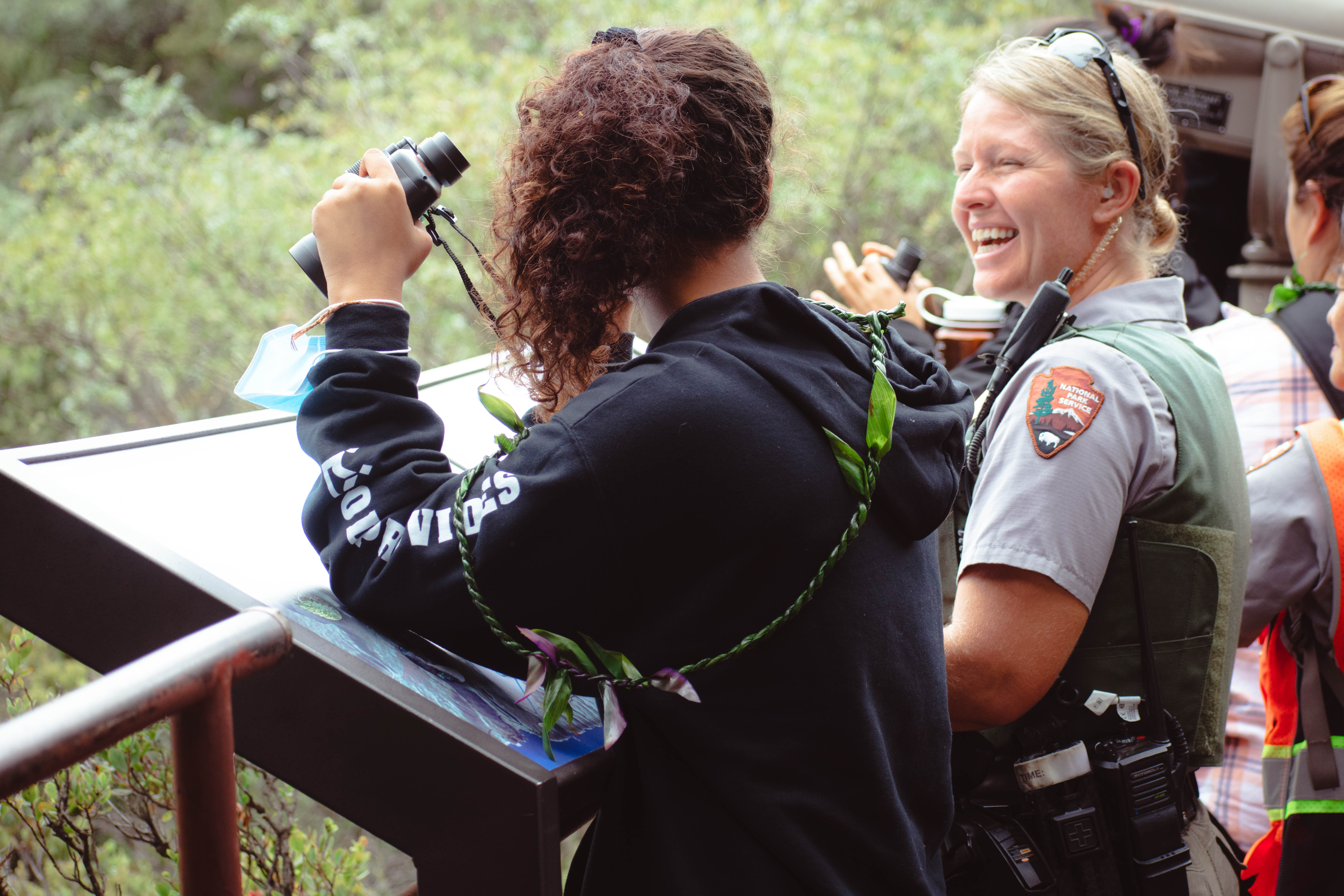 Ranger smiles and interacts with visitor at overlook