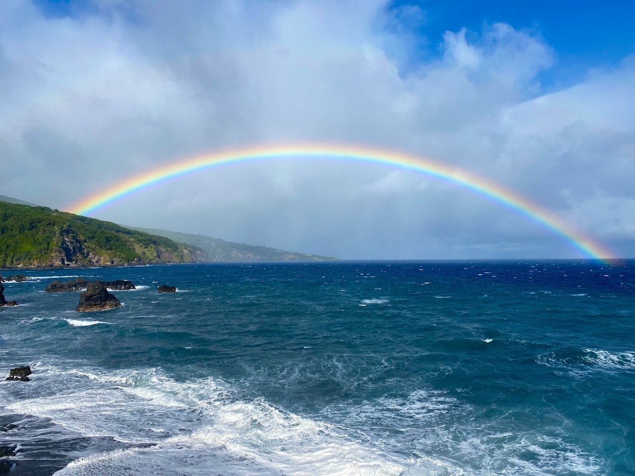 A rainbow in the distance from Kuloa Point in the Kipahulu District of Haleakala National Park