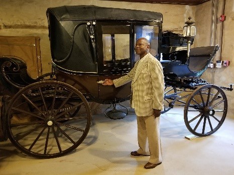 Mr. John Gross stands with one of the carriages his ancestor Nathan Harris likely drove at Hampton.