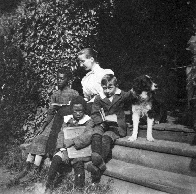 A historic black and white photograph of Margaretta Sophia “Margie” Ridgely with students.