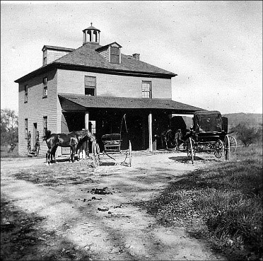 Historic black and white photo of the carriage house.