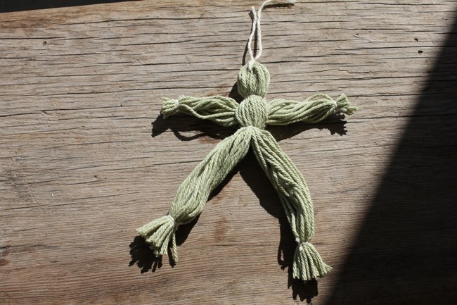 A bundle of yarn tied up to look like a doll.