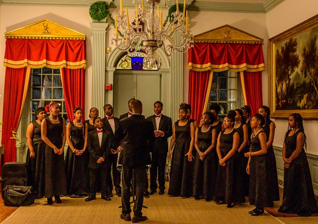 ConneXions Academy student choir performing in great hall of mansion.