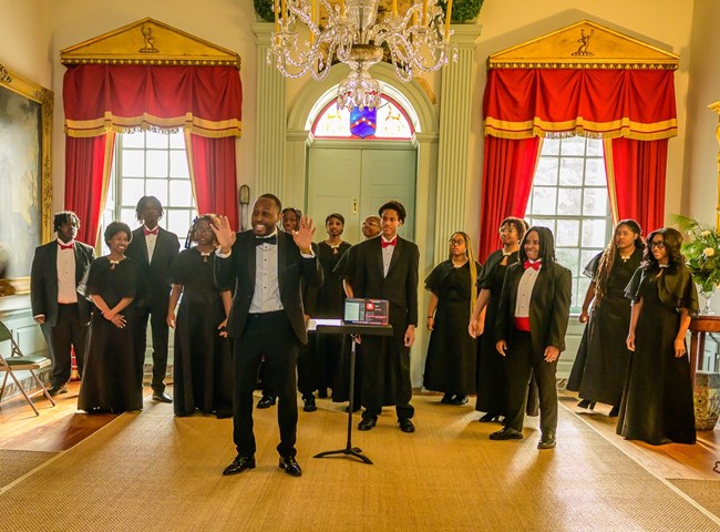ConneXions Academy student choir performing in great hall of mansion.
