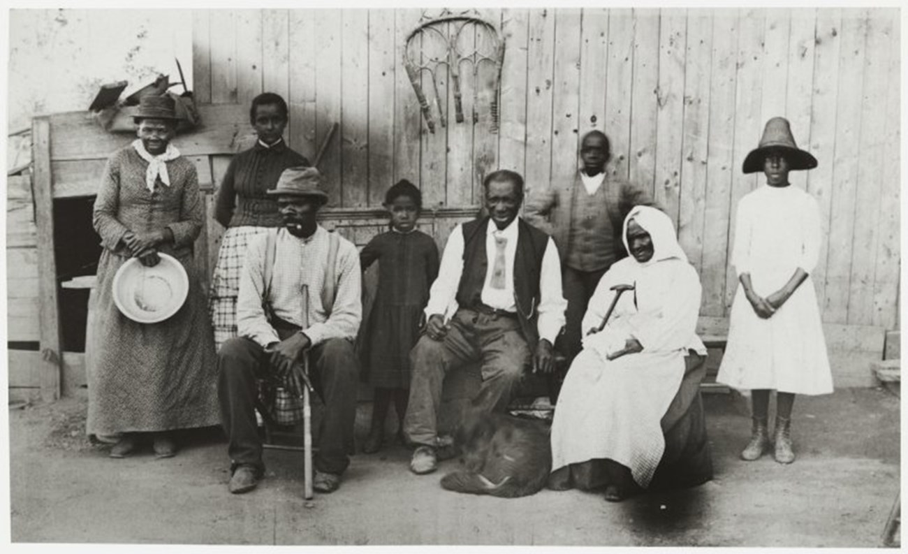 Black and white photograph of Tubman standing with her family.