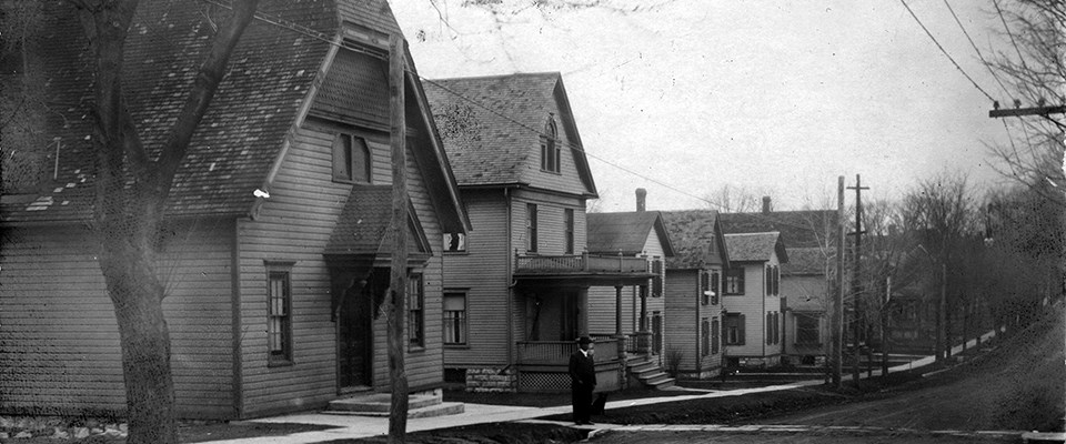 Historic photo of Parker Street. Wooden Thompson AMEZ Church on far left, parsonage next door.