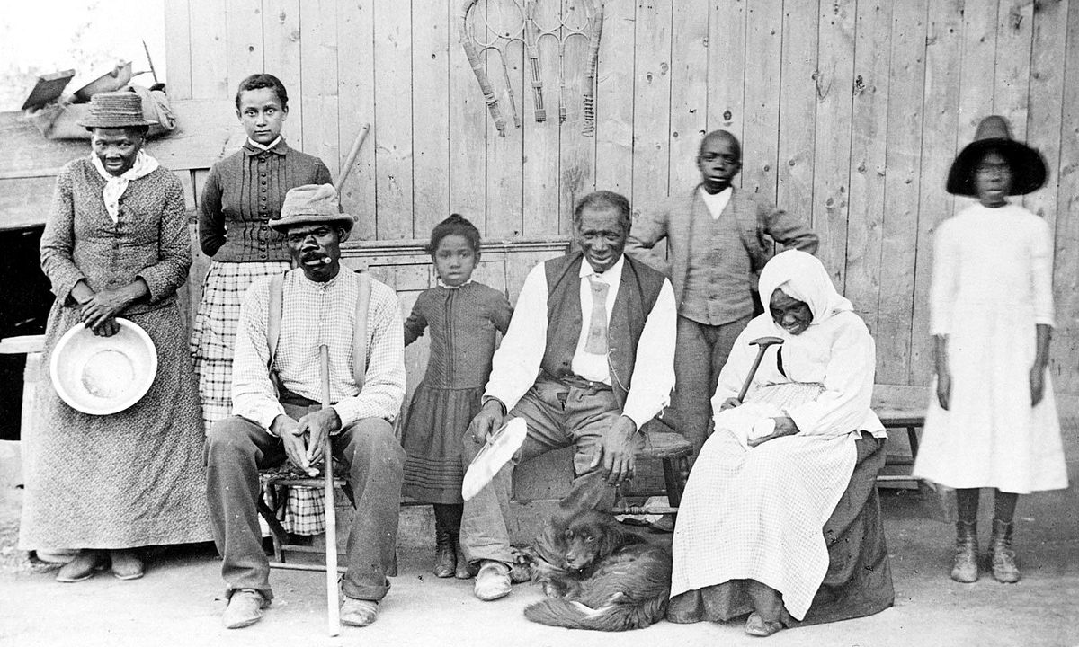 Harriet Tubman (c. 1820 – March 10, 1913), far left, with family and no neighbors, circa 1887, at her home in Auburn, NY. Left to right: Harriet Tubman; Gertie Davis {Watson} (adopted daughter born 1874, died ?) behind Tubman; Nelson Davis (husband)