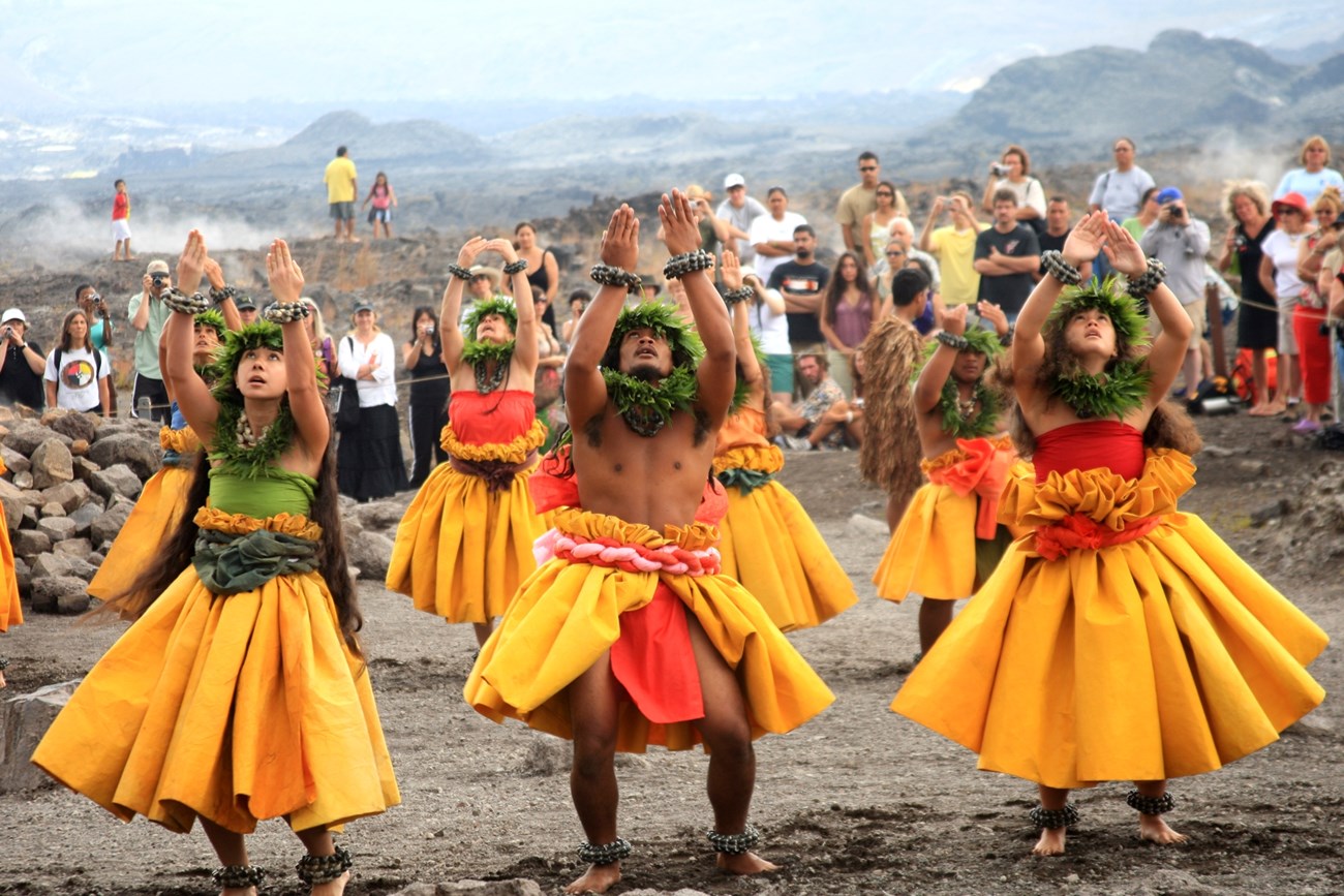 Group of hula practitioners at a crater's edge.