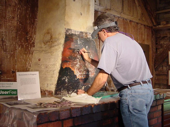 art conservator working in situ