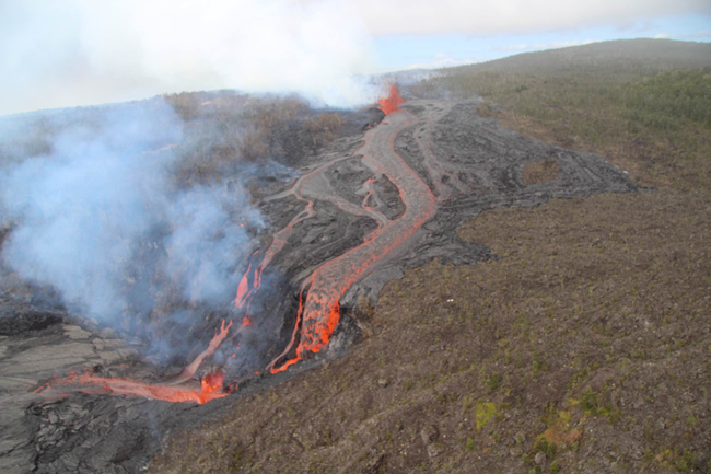 New fissures created a lava fall on September 19 Bright red lava flowing from a fissure high up down a hill and cliff into a crater