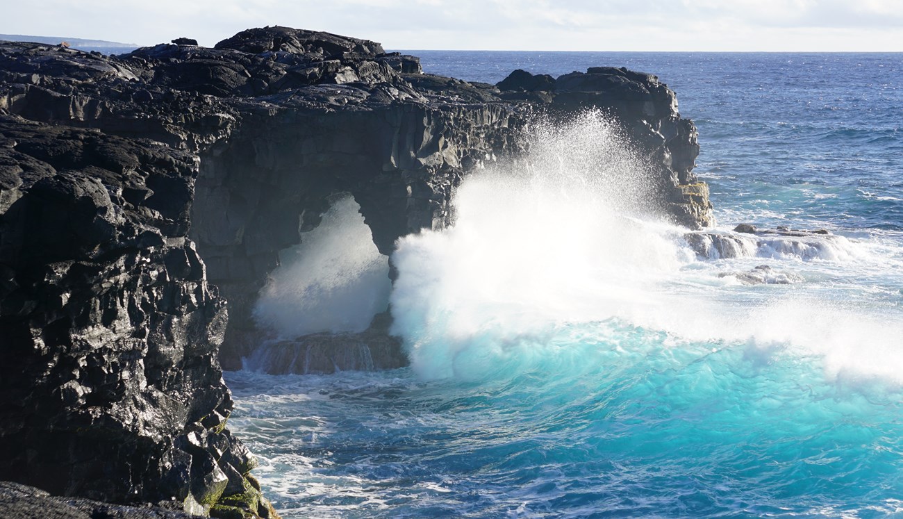 Waves striking coastal cliffs