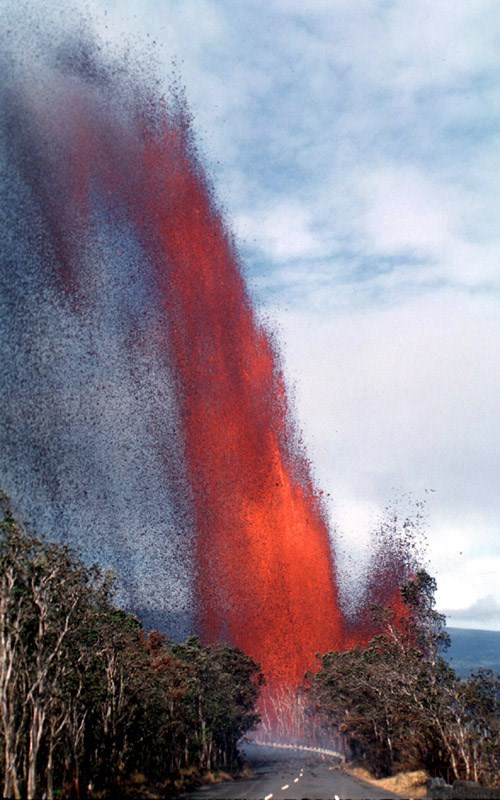 Tall lava fountain at edge of road