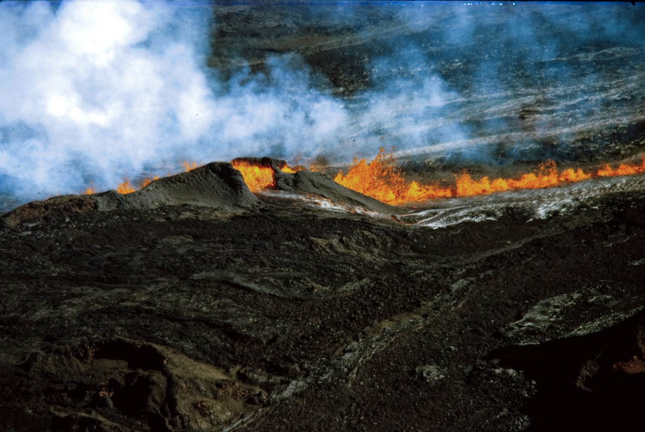 Aerial view of erupting lava vents with plumes of gas