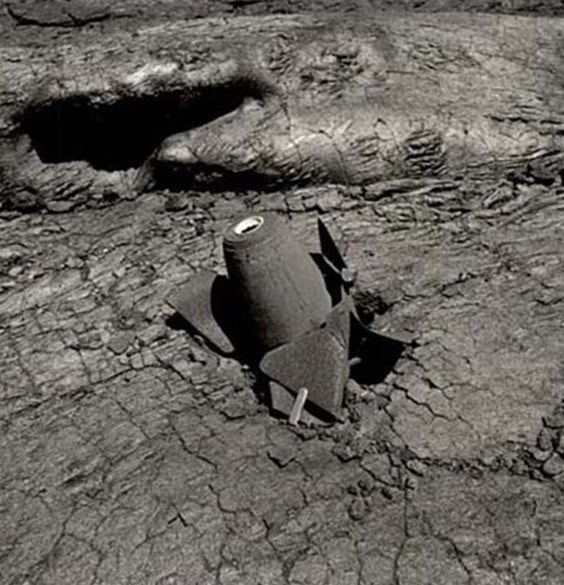 Black and white photo of a bomb stuck in lava