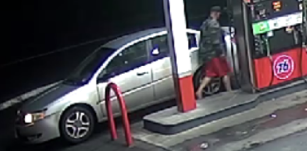 Male theft suspect near car at gas station